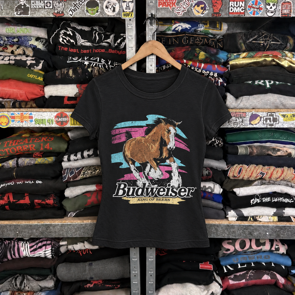 99 Stallion Womens Black Tee — off-body front on wooden hanger
