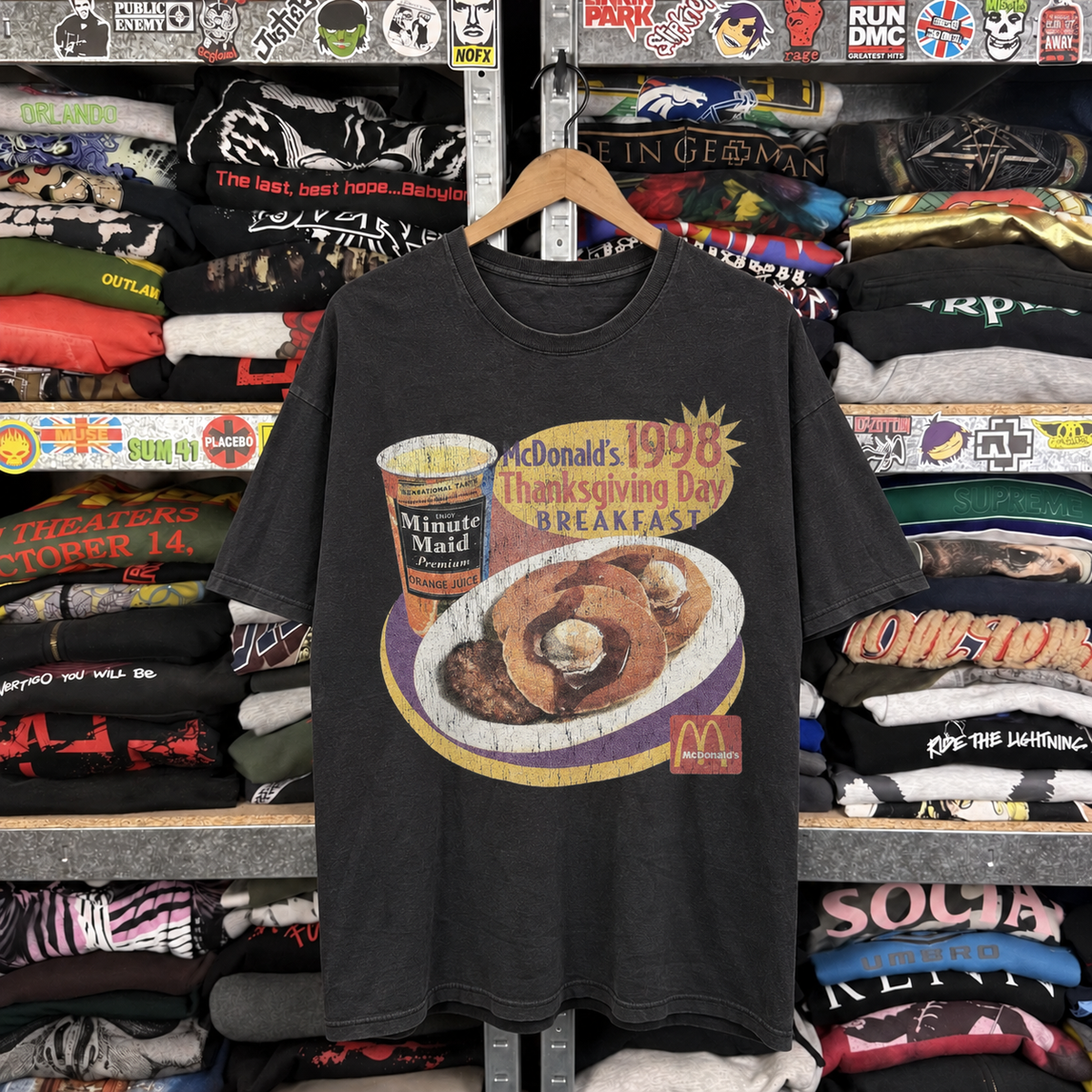 98 Thanksgiving Breakfast Vintage Washed Black T-Shirt — off-body front on wooden hanger