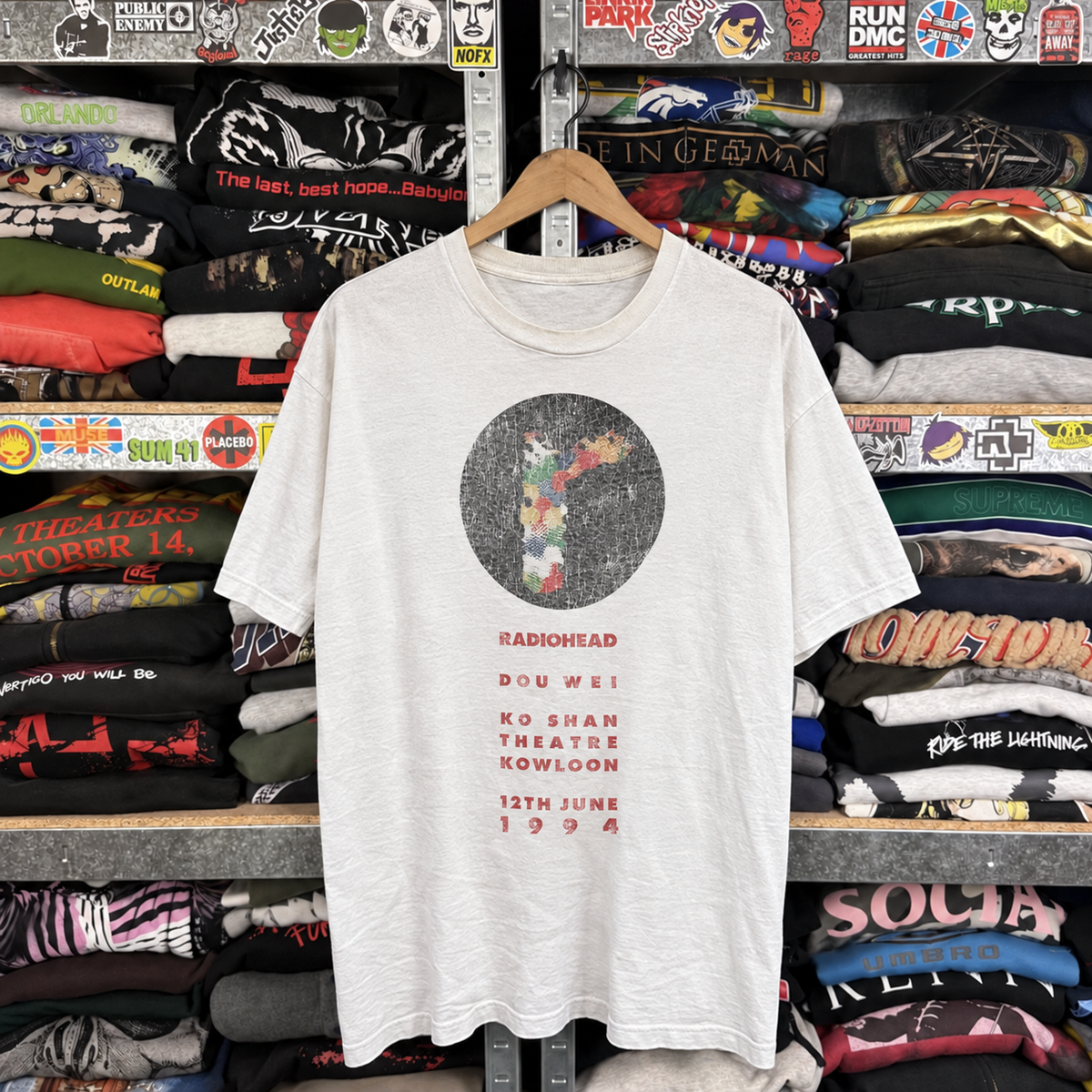 1994 Radiohead 'Hong Kong' Honey Pablo Ultra Rare Washed White T-Shirt — off-body front on wooden hanger